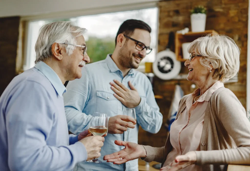 happy-mature-couple-having-fun-while-communicating-with-their-adult-son-kitchen